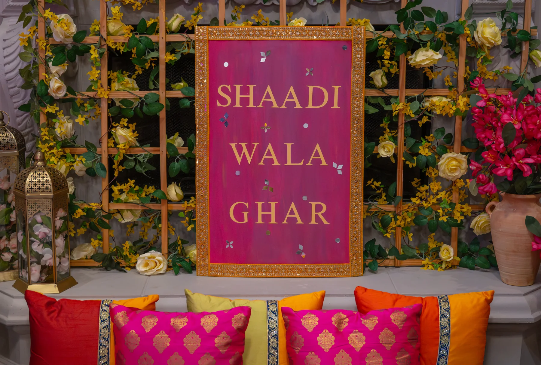 A colorful celebration sign surrounded by flowers