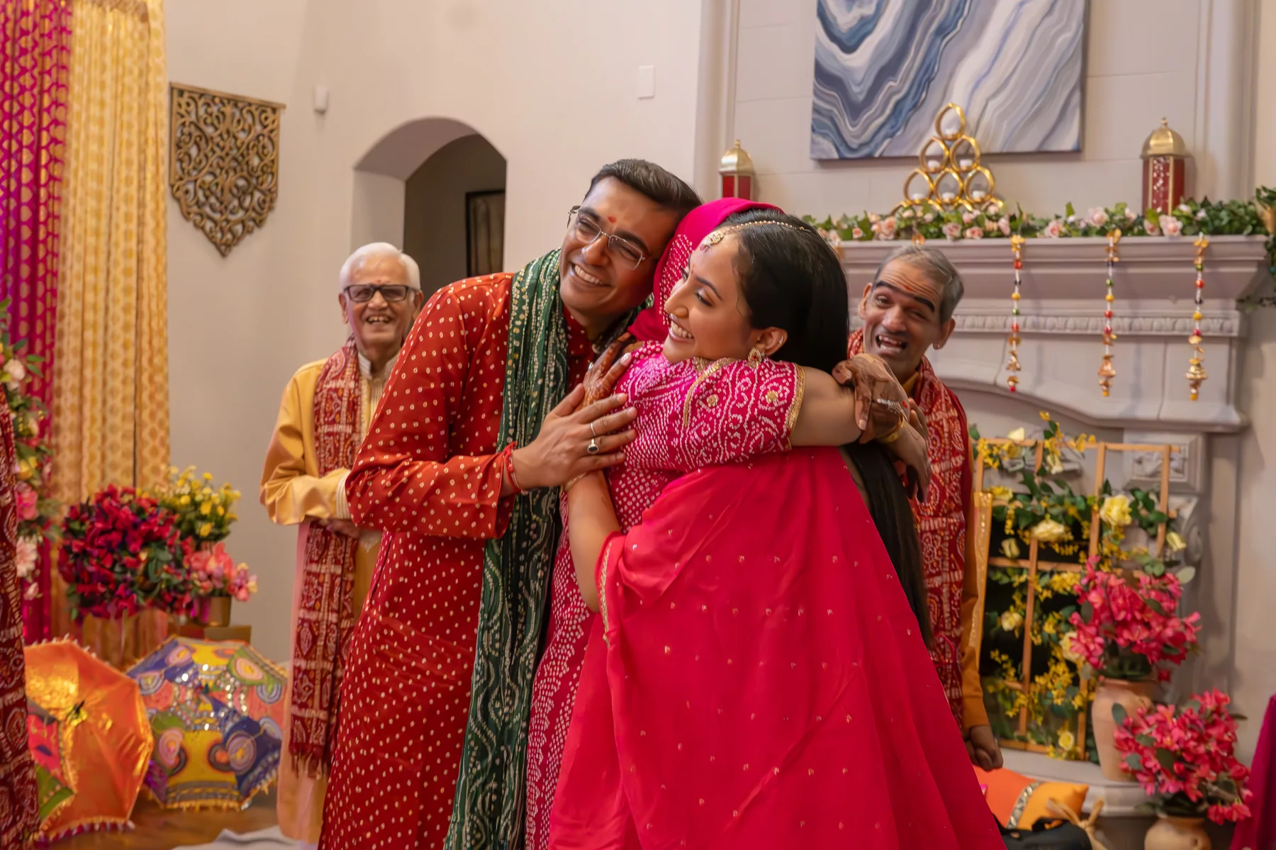 People embracing in bright clothing at a celebration