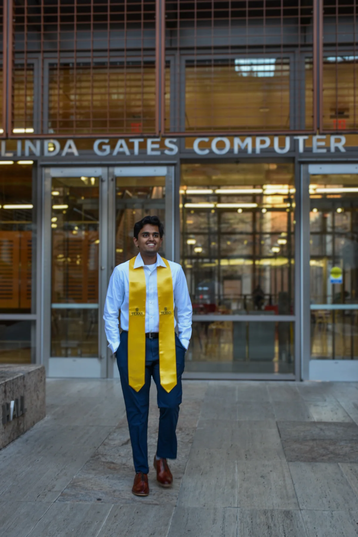 Graduate in a cap and stole outside a university building