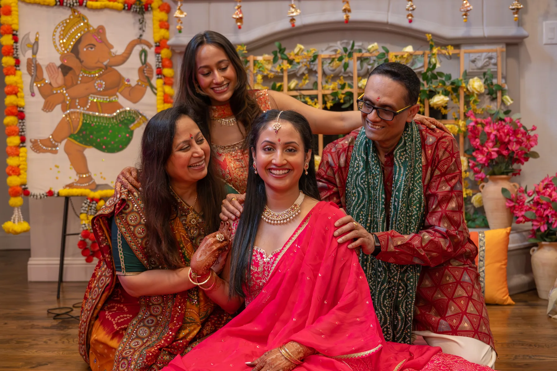 People gathered together in front of a colorful celebration backdrop