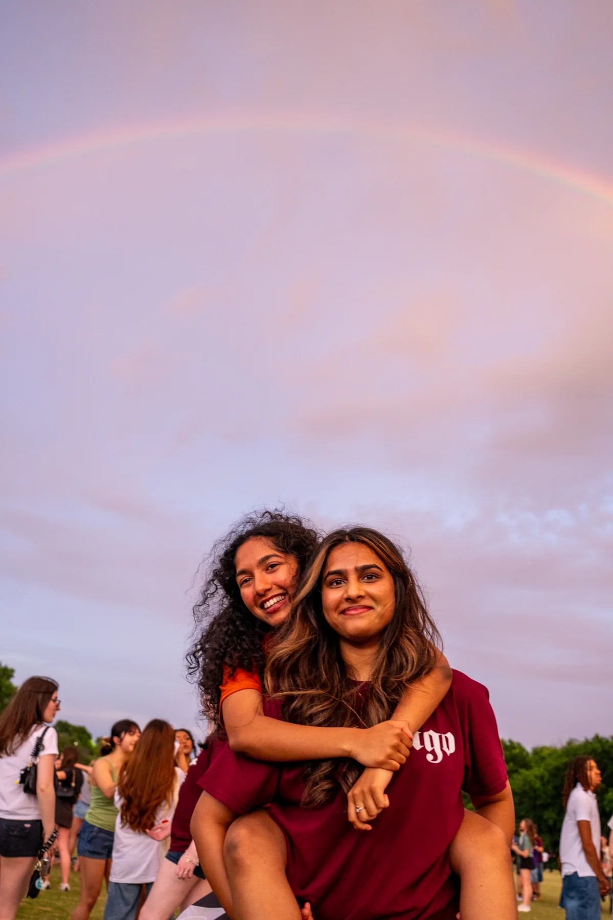 Two people together beneath a pastel evening sky