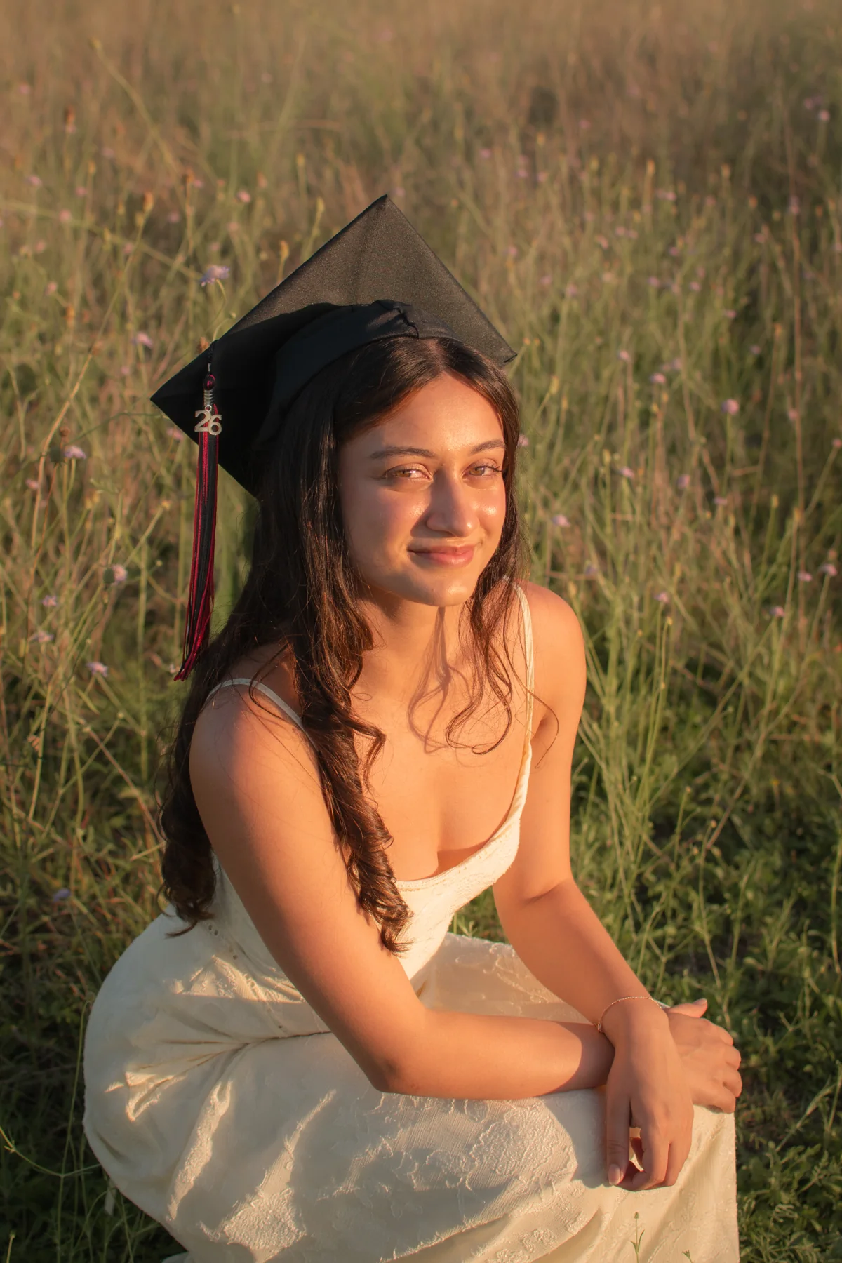 Portrait seated among golden grass in late afternoon light