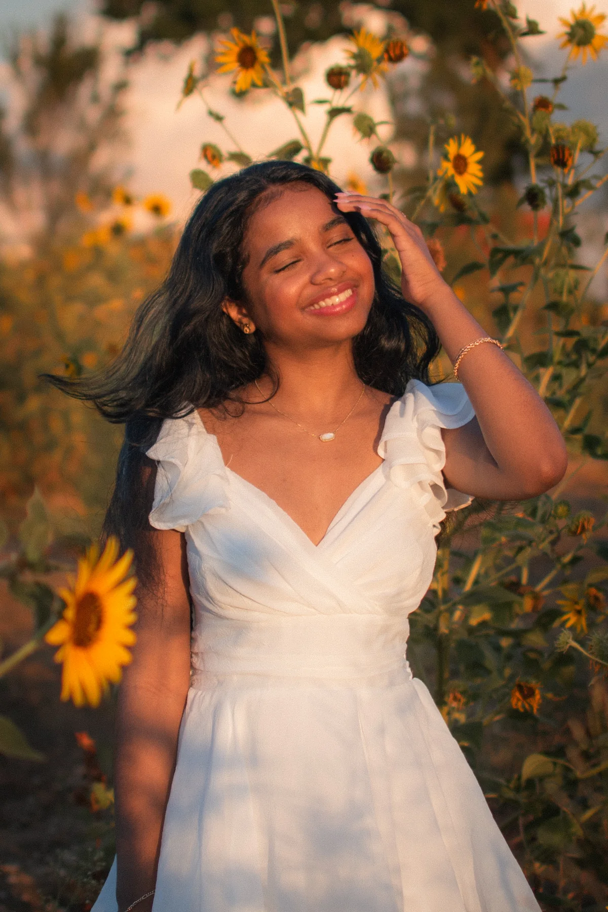 Portrait in a white dress among tall sunflowers
